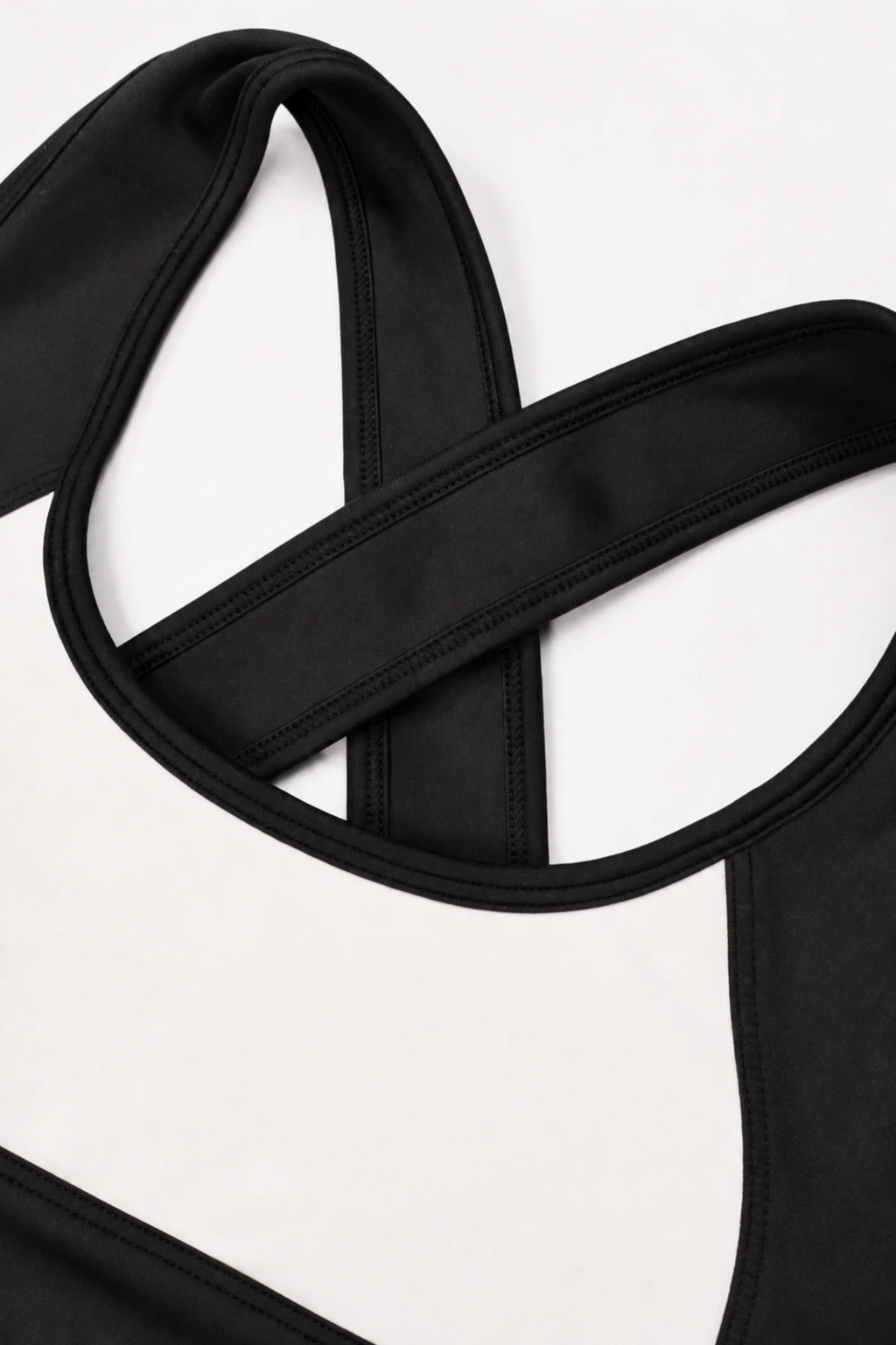 Closeup of white and black color block sports bra 